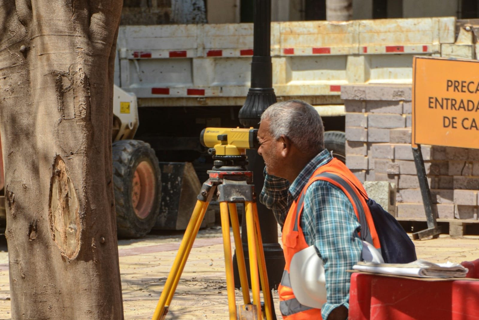 A surveyor setting an instrument on a live site