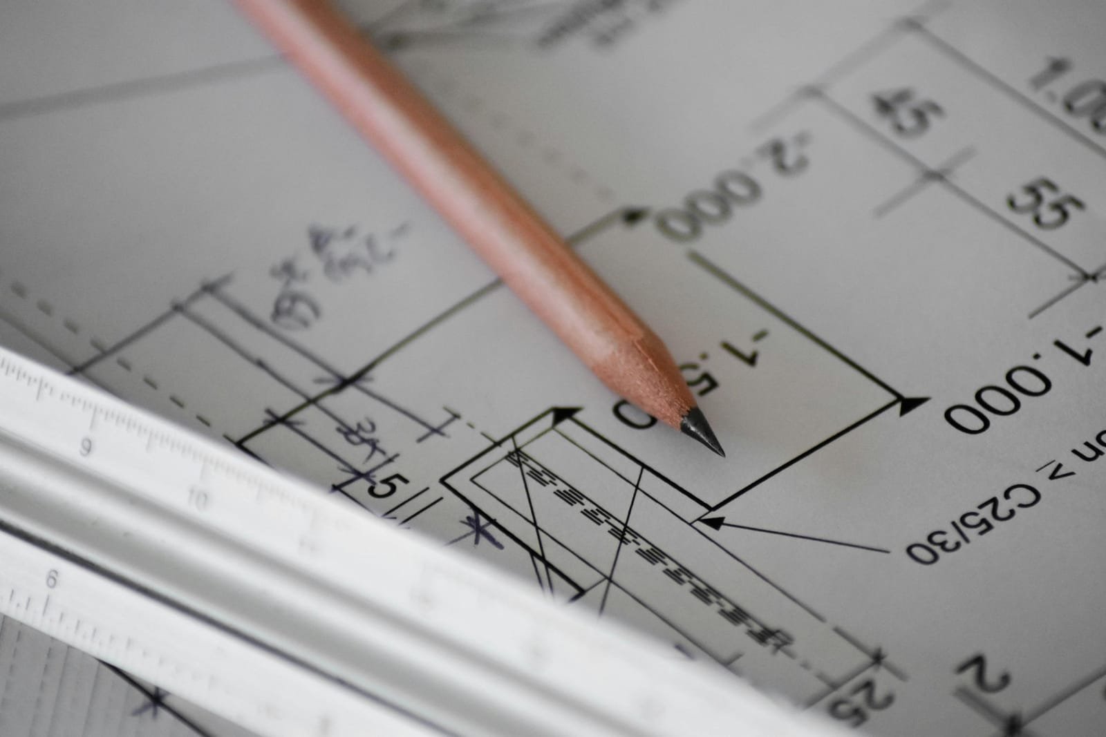 A structural drawing with a pencil and scale rule, concrete grade C25/30 noted